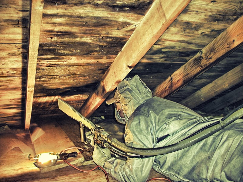 Dry ice blasting mold remediation in confined attic space — operator in full protective gear